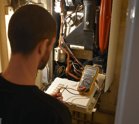 Gas safe engineer running tests on a central heating system in Edinburgh.