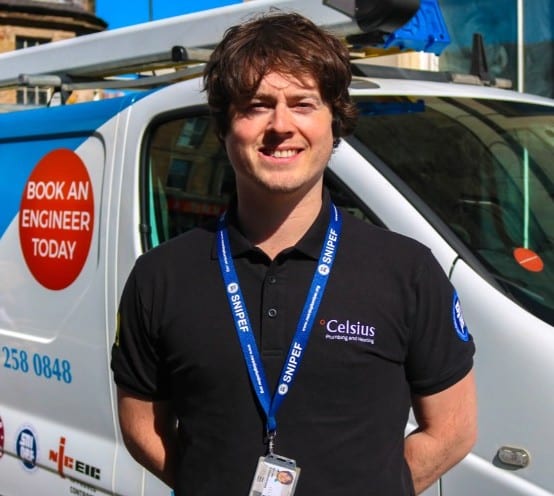 Celsius plumber and heating engineer standing at his van.