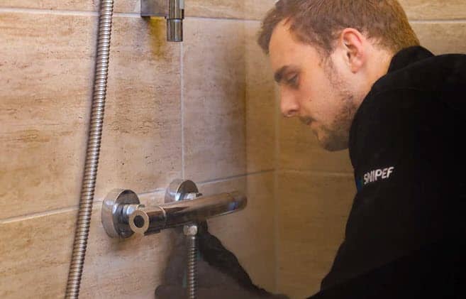 Celsius plumber undertaking a shower repair in Edinburgh.