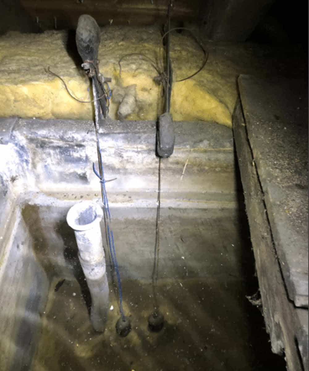 Lead water tank identified during an inspection in Edinburgh rental home.