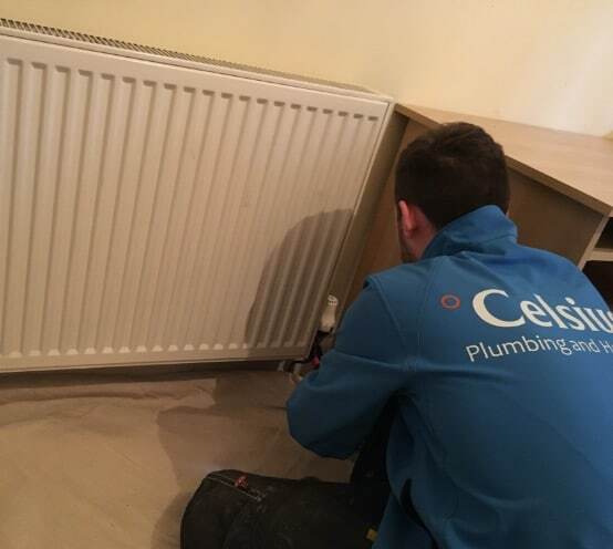 Celsius plumber working on a radiator in an Edinburgh landlord's rental property.