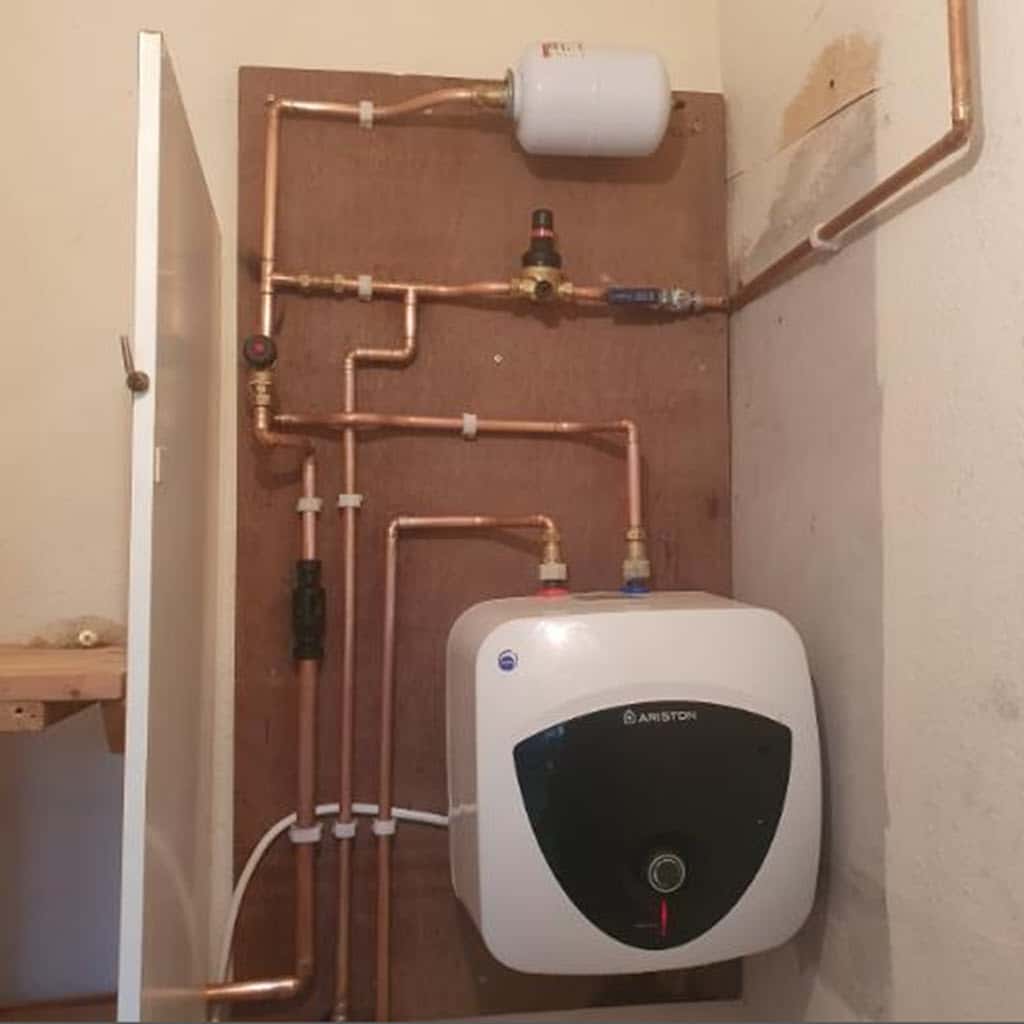 Celsius plumbers installing a new Ariston mains water heater.