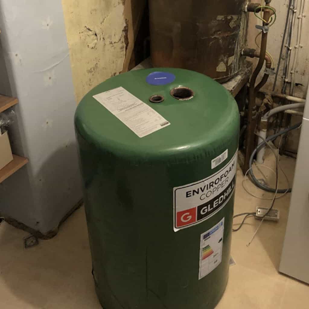 Replacing an old gravity hot water tank with a new insulated tank.