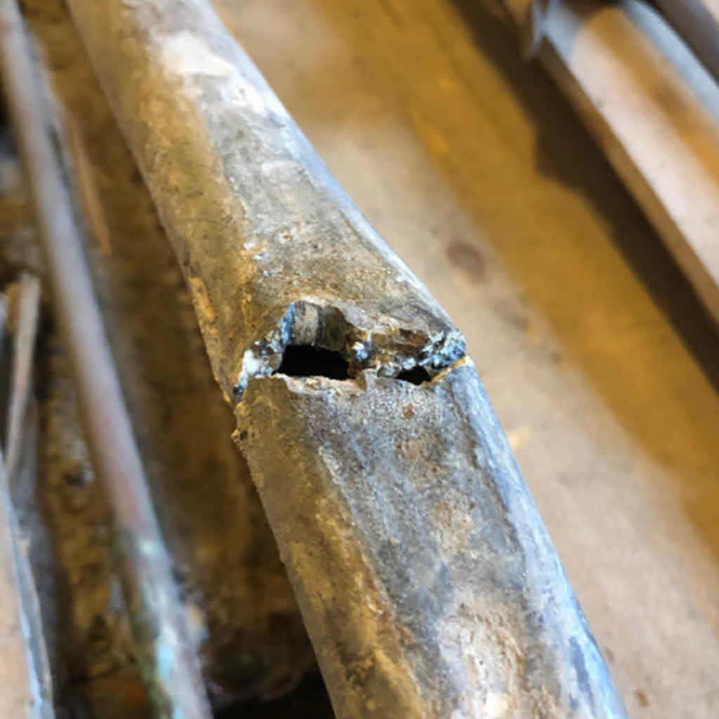 This lead pipe cracked causing a leak - now being repaired by a Celsius plumber.